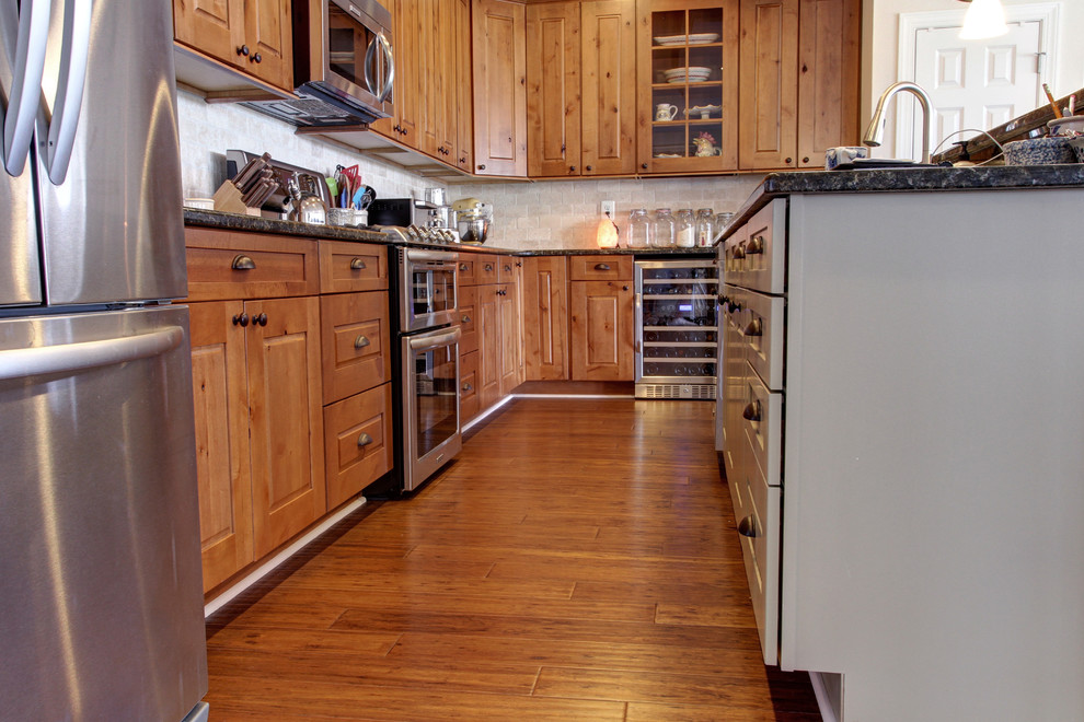 This is an example of a country kitchen in Baltimore with light hardwood floors and brown floor.