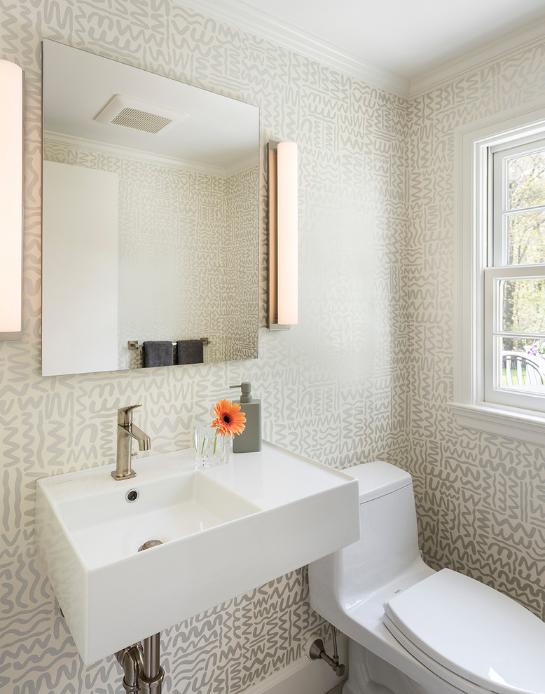 Photo of a transitional powder room in Boston with grey walls and a wall-mount sink.