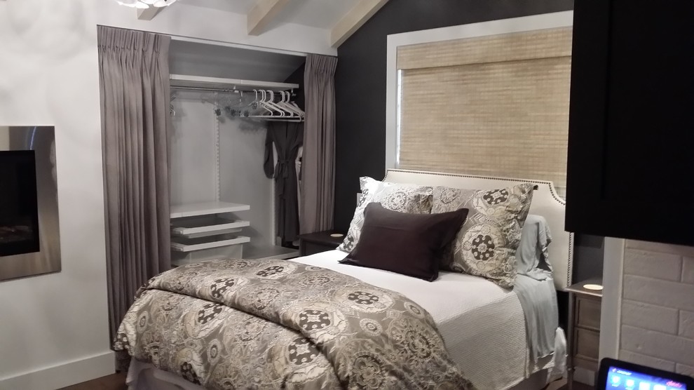 Inspiration for a mid-sized transitional medium tone wood floor and brown floor bedroom remodel with no fireplace and gray walls