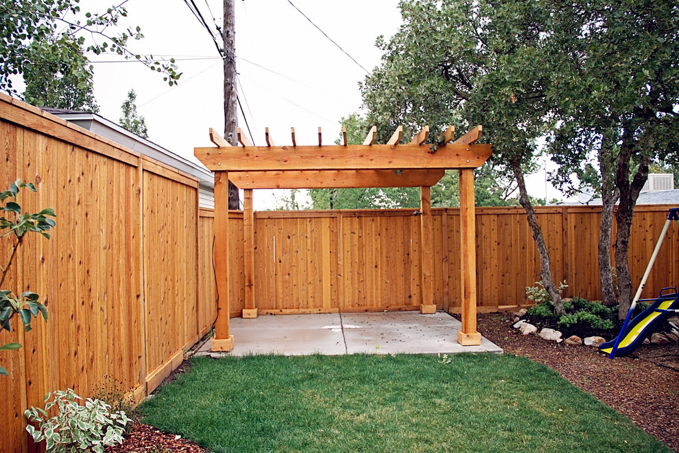 This is an example of a mid-sized arts and crafts backyard patio in Salt Lake City with concrete slab and a pergola.