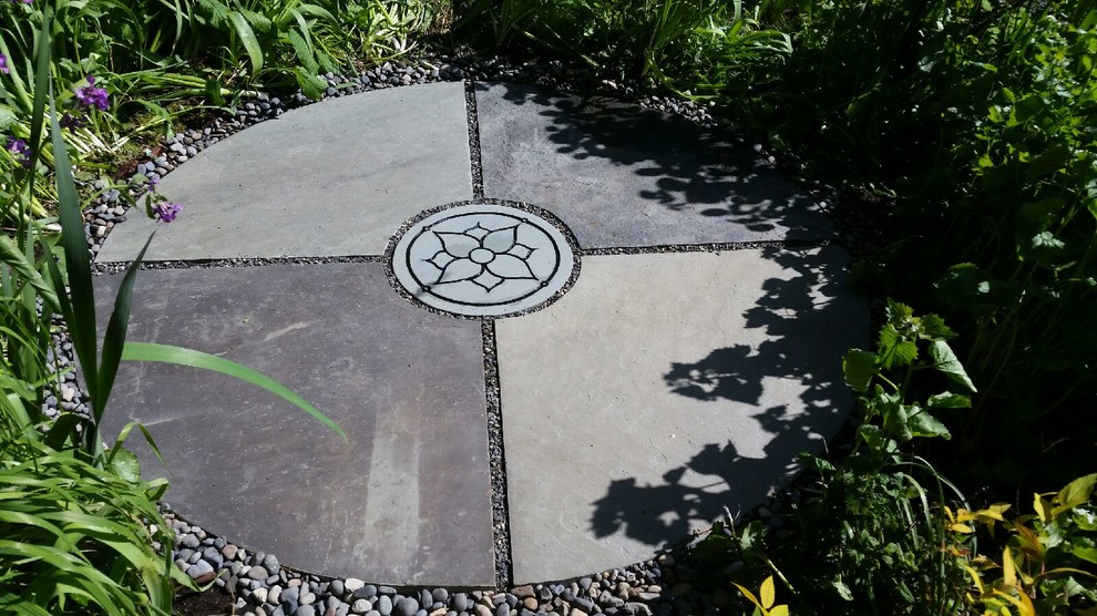 This is an example of a small asian backyard partial sun garden in Portland with natural stone pavers.