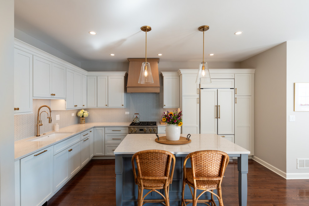 Example of a transitional kitchen design in Chicago with shaker cabinets, white cabinets, quartz countertops, mosaic tile backsplash and white countertops