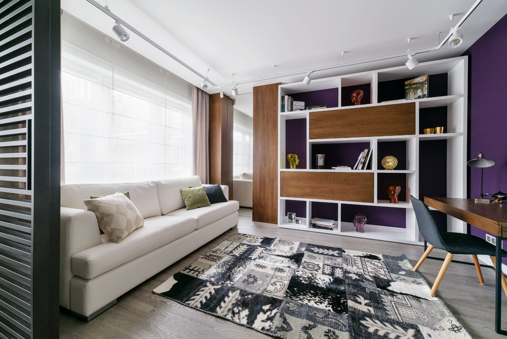 This is an example of a contemporary formal open concept living room in Other with purple walls, light hardwood floors and grey floor.