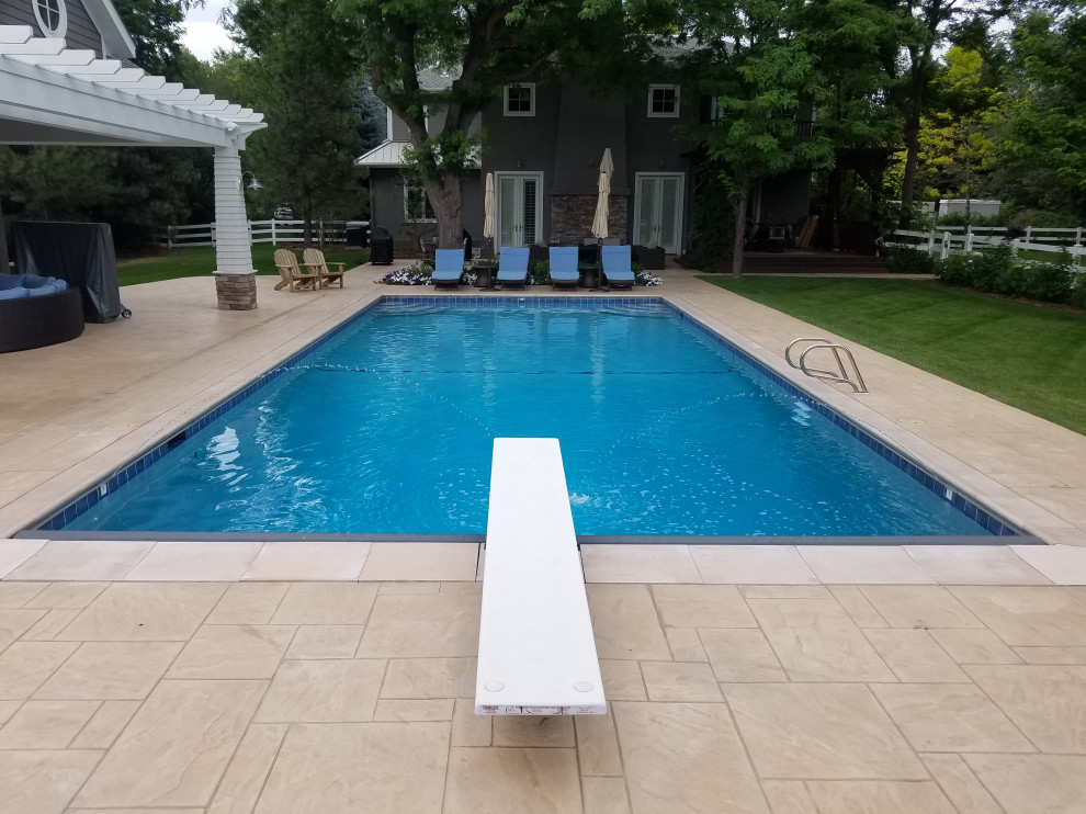 Pool - large backyard rectangular pool idea in Denver