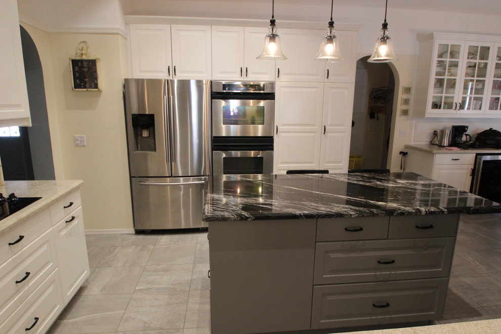 Mid-sized transitional u-shaped ceramic tile enclosed kitchen photo in Phoenix with a double-bowl sink, raised-panel cabinets, white cabinets, marble countertops, gray backsplash, ceramic backsplash, stainless steel appliances and an island