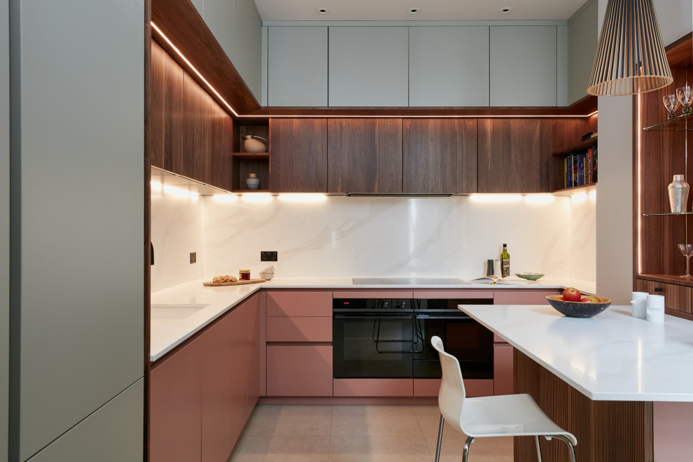 Photo of a small contemporary l-shaped eat-in kitchen in London with an integrated sink, louvered cabinets, red cabinets, quartzite benchtops, beige splashback, engineered quartz splashback, black appliances, ceramic floors, with island, brown floor and beige benchtop.