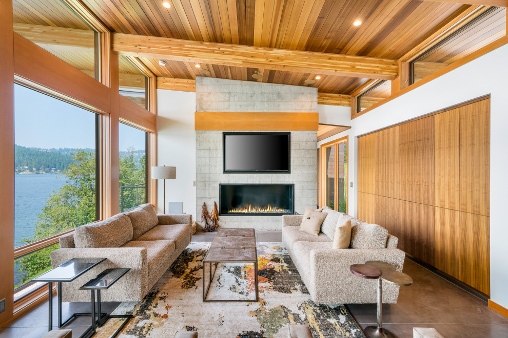 Large contemporary open concept living room in Other with white walls, concrete floors, a ribbon fireplace, a concrete fireplace surround, a wall-mounted tv, grey floor and wood.