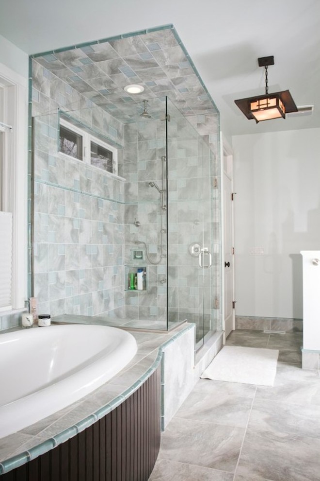 Large transitional master bathroom in Cleveland with a drop-in tub, a corner shower, gray tile, ceramic tile, white walls, ceramic floors, grey floor, a hinged shower door, flat-panel cabinets, dark wood cabinets, a drop-in sink and engineered quartz benchtops.