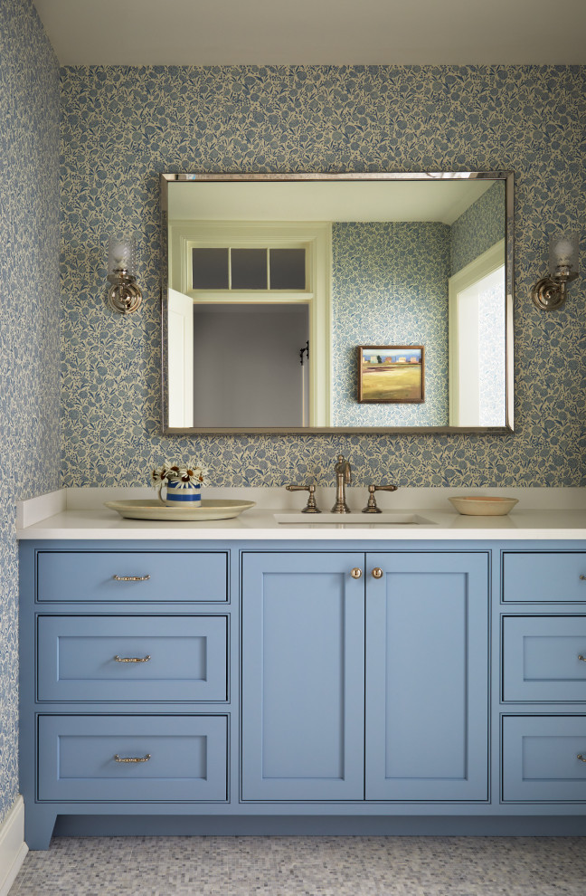 Inspiration for a medium sized rural family bathroom in Boston with beaded cabinets, blue cabinets, a claw-foot bath, a corner shower, blue walls, marble flooring, a submerged sink, engineered stone worktops, blue floors, a hinged door, white worktops, a single sink, a built in vanity unit and wallpapered walls.