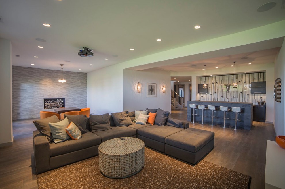 Example of a large transitional walk-out dark wood floor basement design in Chicago with white walls, a standard fireplace and a tile fireplace