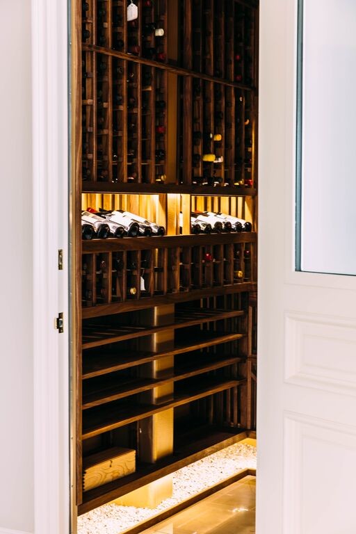 Photo of a small transitional wine cellar in Los Angeles with marble floors and storage racks.
