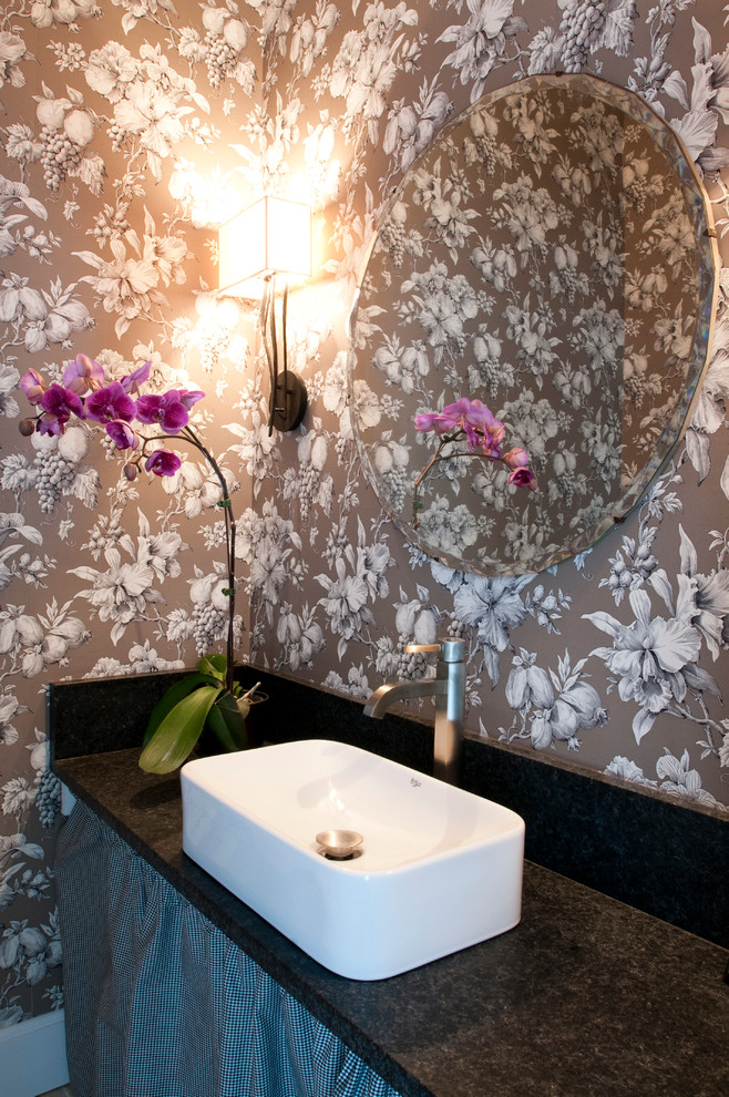 This is an example of a mid-sized traditional powder room in New York with granite benchtops and a vessel sink.