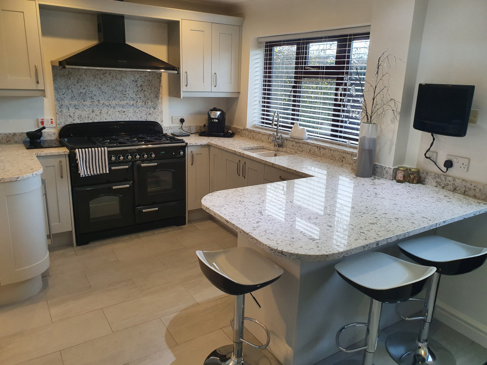 Inspiration for a mid-sized modern u-shaped separate kitchen in West Midlands with an integrated sink, shaker cabinets, grey cabinets, quartzite benchtops, multi-coloured splashback, black appliances, ceramic floors, no island, grey floor and multi-coloured benchtop.
