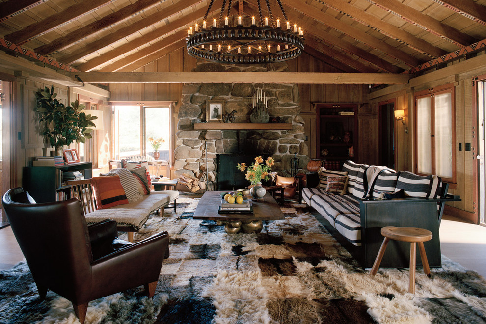 Design ideas for a country living room in Los Angeles with beige walls, a standard fireplace and a stone fireplace surround.