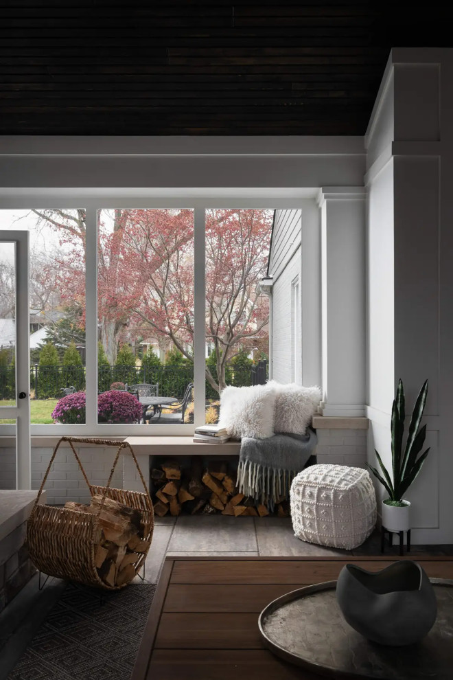 Sunroom - large transitional concrete floor and gray floor sunroom idea in Detroit with a standard fireplace and a stone fireplace
