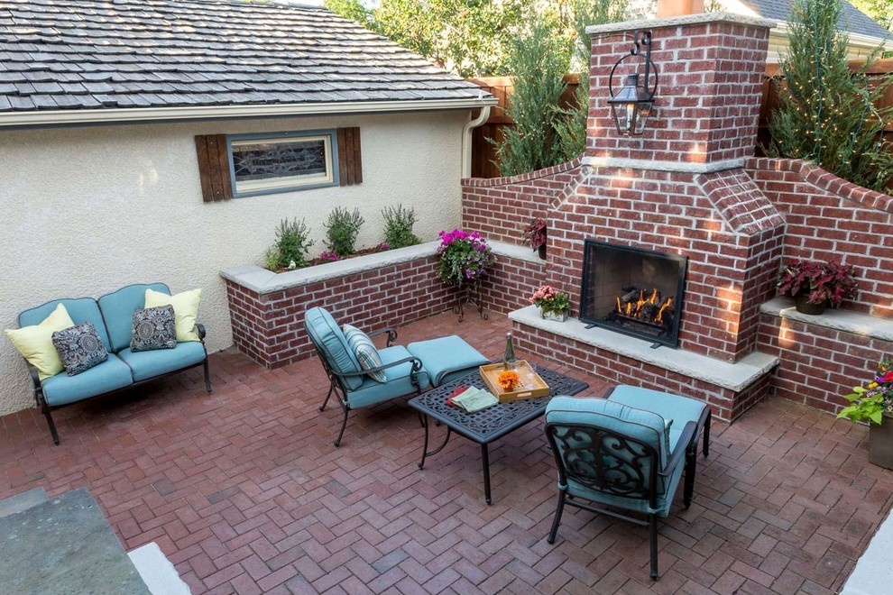 Photo of a small arts and crafts backyard patio in Minneapolis with with fireplace and brick pavers.