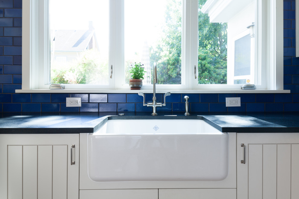 Photo of an eclectic u-shaped kitchen in Portland with beaded inset cabinets, white cabinets, granite benchtops, blue splashback and ceramic splashback.