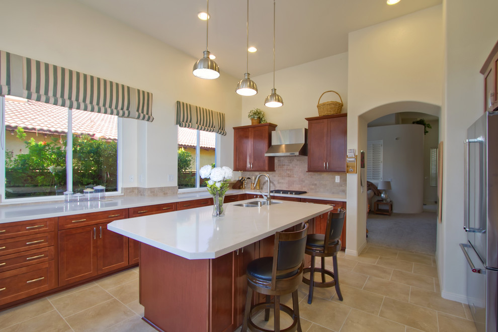 This is an example of a large modern u-shaped eat-in kitchen in Los Angeles with a double-bowl sink, recessed-panel cabinets, brown cabinets, beige splashback, stone tile splashback, stainless steel appliances, porcelain floors, with island, beige floor, white benchtop and quartz benchtops.