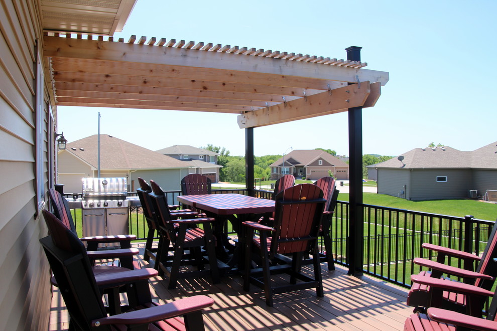 Large backyard deck photo with a pergola