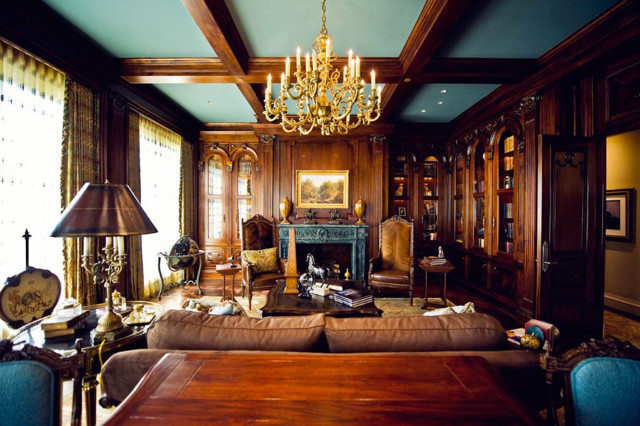 Study room - large freestanding desk study room idea in Dallas with blue walls, a standard fireplace and a stone fireplace