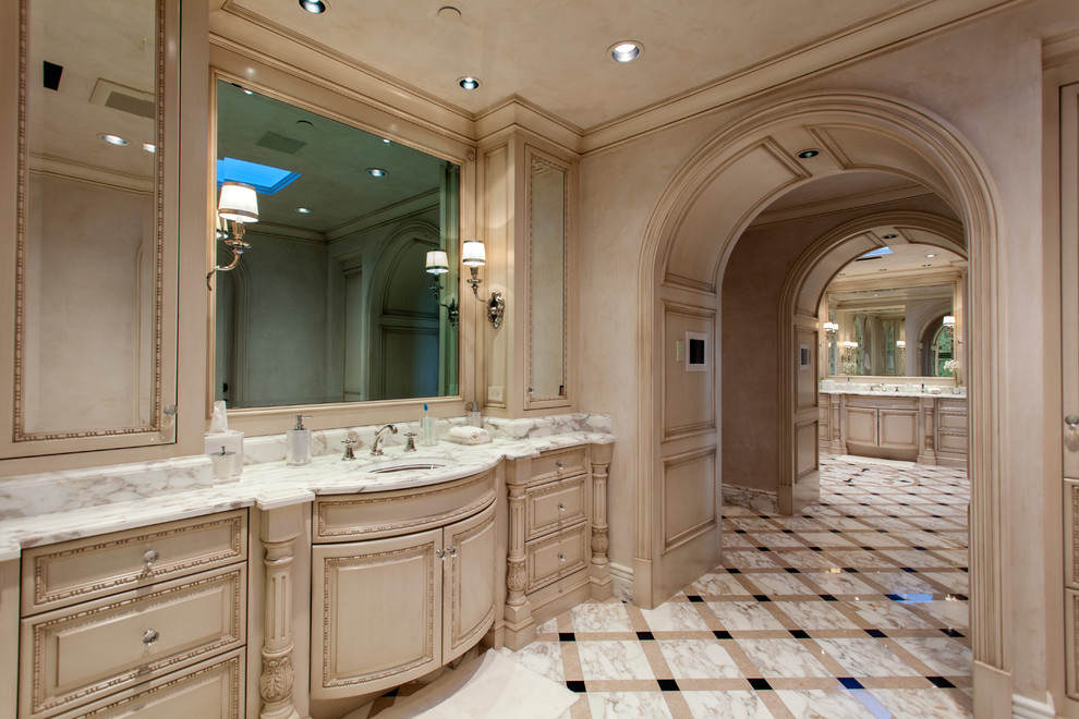 Photo of a mediterranean bathroom in Orange County with furniture-like cabinets, beige cabinets, beige walls, a drop-in sink, multi-coloured floor and green benchtops.