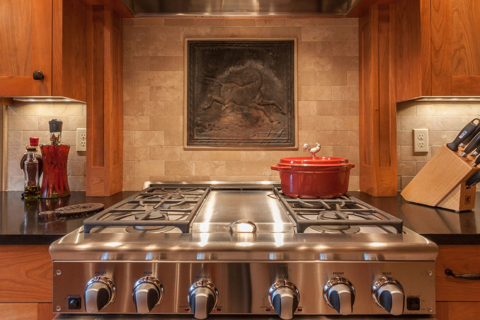 Large transitional porcelain tile and beige floor open concept kitchen photo in Seattle with an undermount sink, shaker cabinets, medium tone wood cabinets, solid surface countertops, beige backsplash, stone tile backsplash, stainless steel appliances and an island
