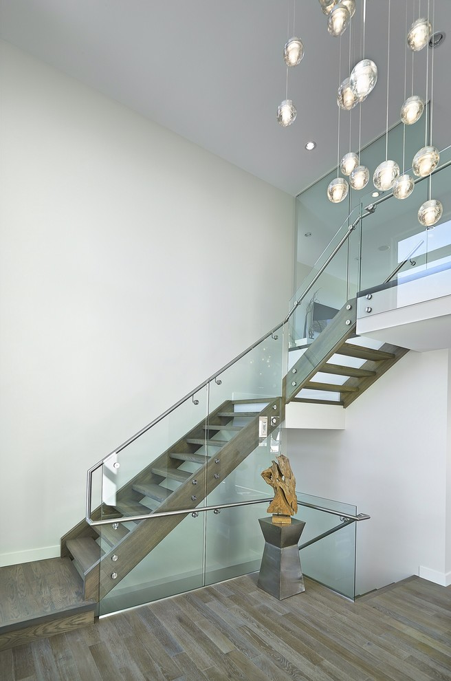 Photo of a contemporary wood l-shaped staircase in Edmonton with open risers.