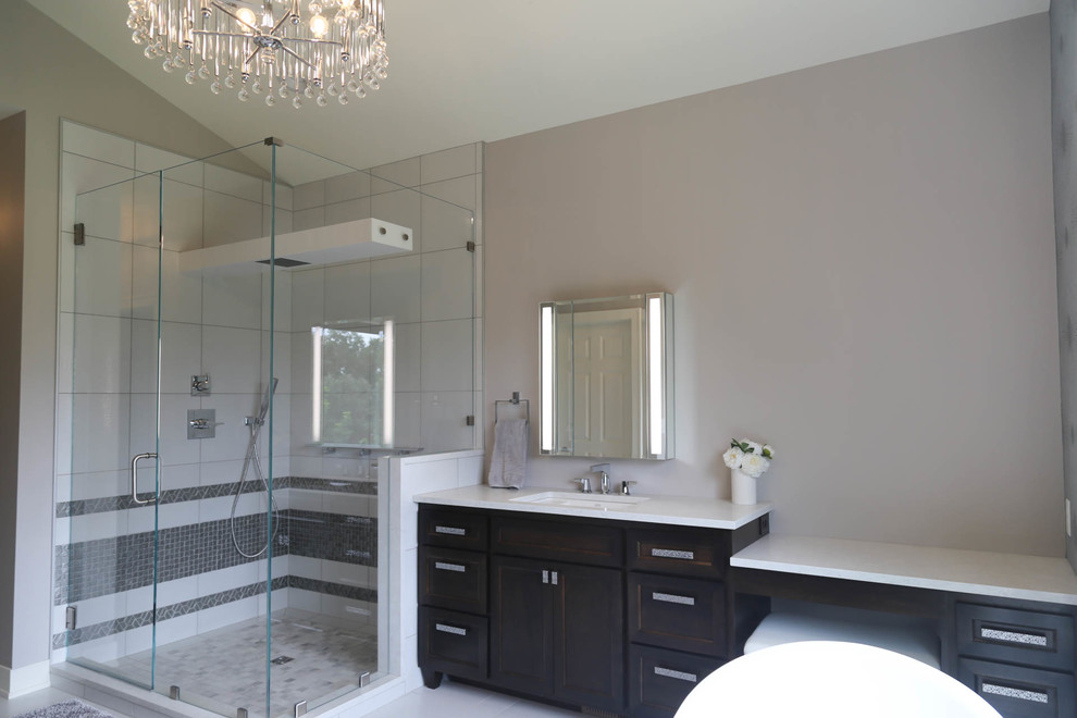 Freestanding bathtub - mid-sized transitional master white tile and porcelain tile porcelain tile and white floor freestanding bathtub idea with recessed-panel cabinets, dark wood cabinets, a two-piece toilet, gray walls, an undermount sink, quartzite countertops, a hinged shower door and white countertops