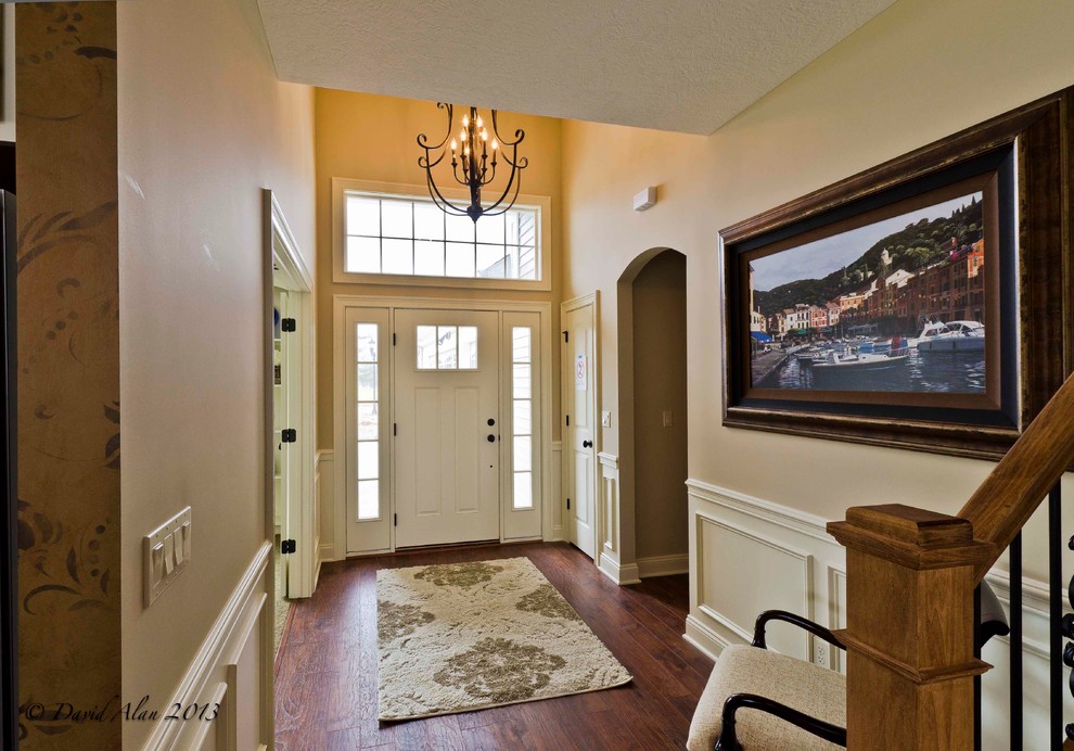 Mid-sized arts and crafts foyer in Cleveland with beige walls, medium hardwood floors, a single front door and a white front door.