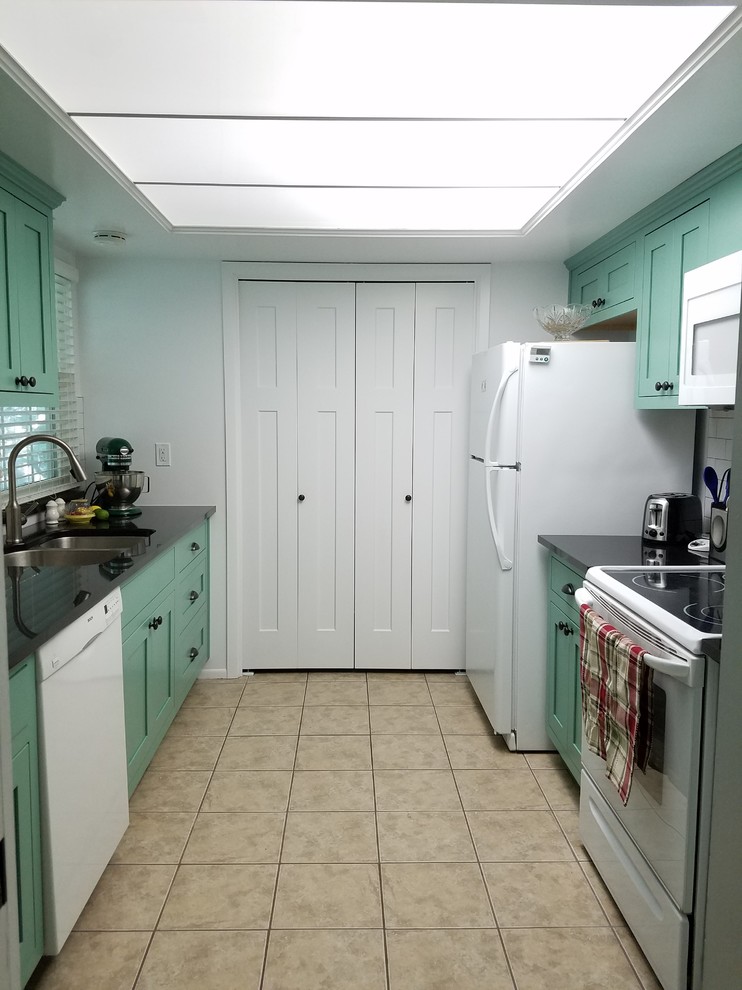 Small transitional galley porcelain tile and beige floor eat-in kitchen photo with a double-bowl sink, shaker cabinets, green cabinets, granite countertops, black backsplash, subway tile backsplash, white appliances and no island