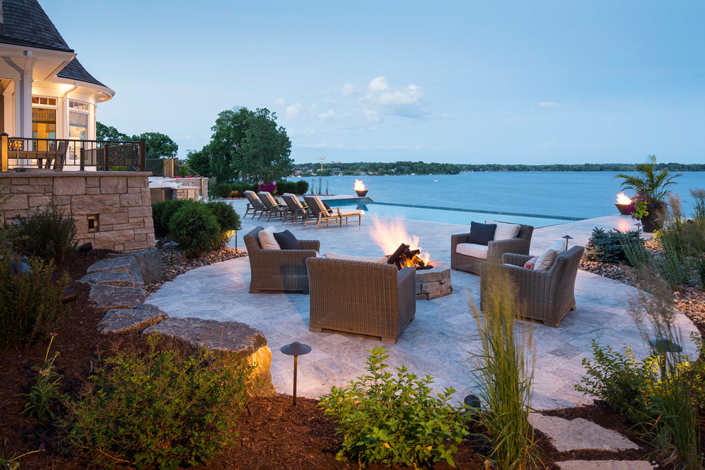 Large contemporary backyard patio in Minneapolis with a fire feature and natural stone pavers.