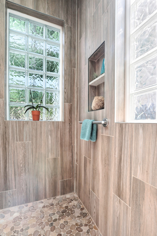Photo of a large beach style master bathroom in San Francisco with shaker cabinets, white cabinets, an undermount tub, a curbless shower, blue tile, porcelain tile, blue walls, porcelain floors, an undermount sink, recycled glass benchtops, brown floor, a hinged shower door and white benchtops.