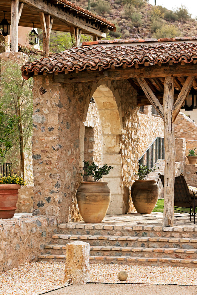 This is an example of a mediterranean patio in Phoenix with brick pavers.