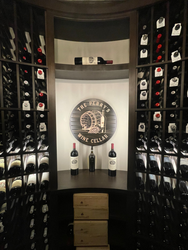 This is an example of a mid-sized traditional wine cellar in Cincinnati with slate floors, display racks and grey floor.