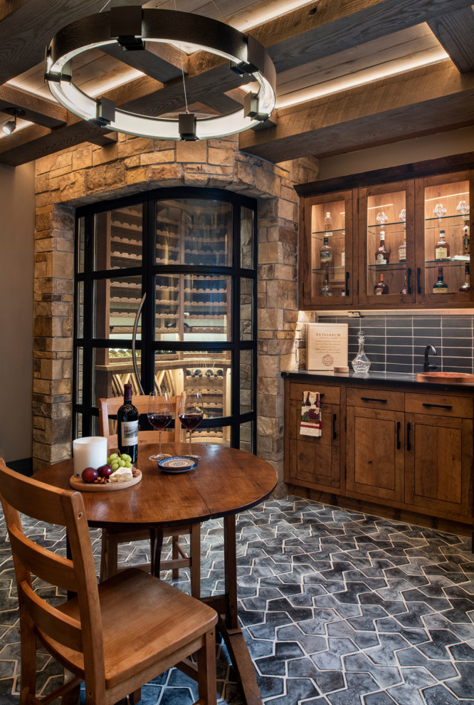 Inspiration for a large arts and crafts wine cellar in Denver with terra-cotta floors, display racks and black floor.