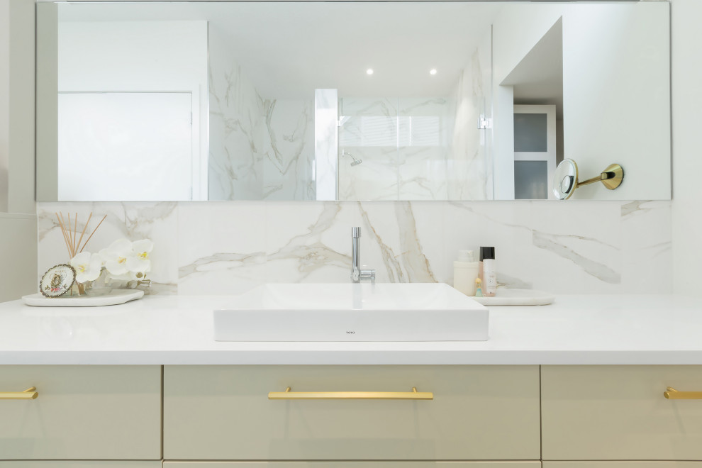 Inspiration for a contemporary master bathroom in Indianapolis with flat-panel cabinets, green cabinets, a corner shower, a bidet, white tile, white walls, an integrated sink, white floor, a hinged shower door, white benchtops, a single vanity, a built-in vanity, marble, marble floors and engineered quartz benchtops.