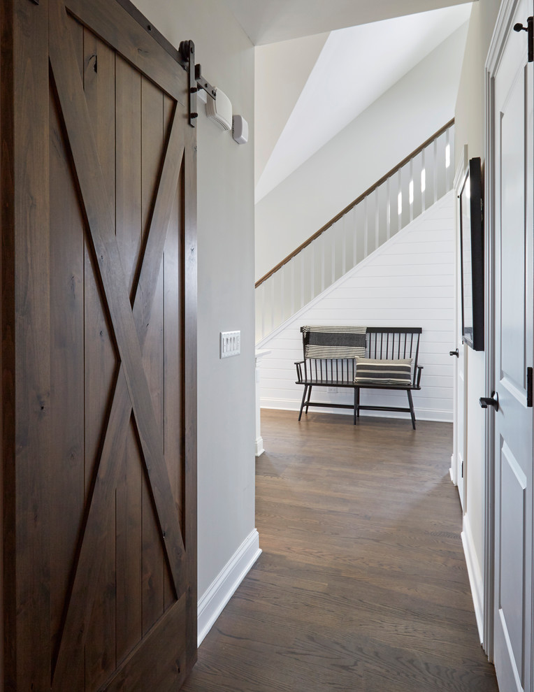 Inspiration for a beach style hallway in Chicago with grey walls, dark hardwood floors and brown floor.