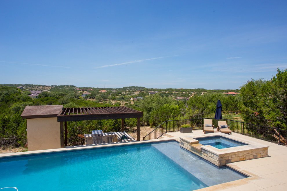 Example of a large transitional backyard concrete and rectangular lap hot tub design in Austin