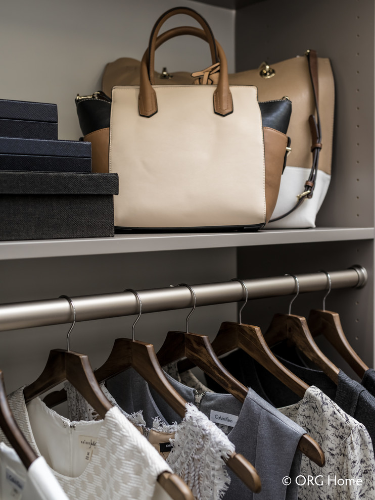 Mid-sized transitional gender-neutral carpeted and beige floor walk-in closet photo with flat-panel cabinets and gray cabinets