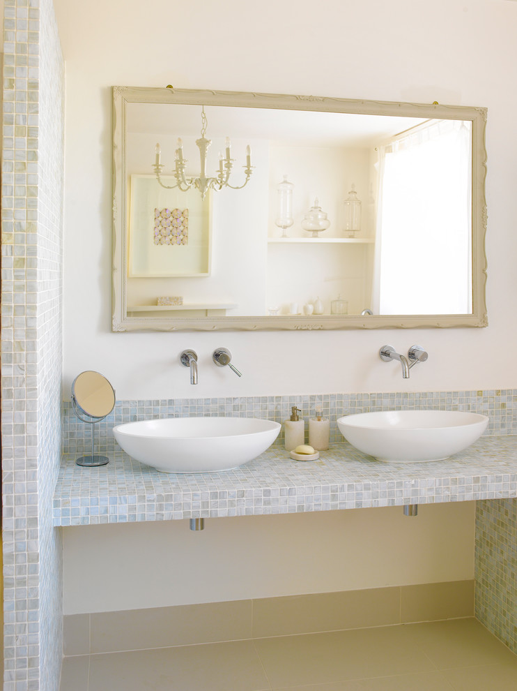 This is an example of a transitional bathroom in London with a vessel sink and gray tile.
