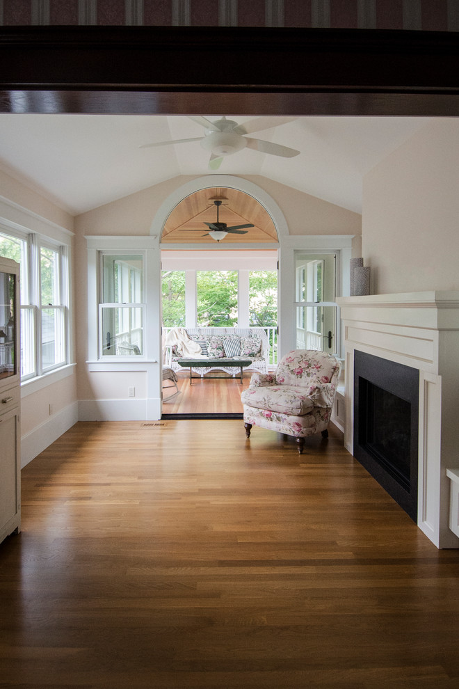 Mid-sized traditional sunroom in Detroit with light hardwood floors, a standard fireplace, a standard ceiling and a tile fireplace surround.