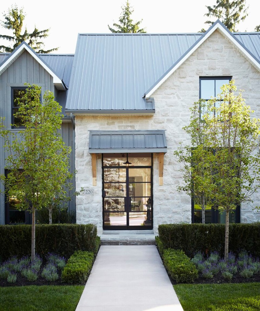Mid-sized contemporary two-storey grey house exterior in Toronto with mixed siding and a metal roof.