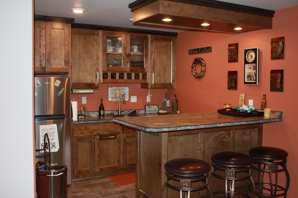 Photo of a mid-sized contemporary galley seated home bar in Other with a drop-in sink, shaker cabinets, medium wood cabinets, laminate benchtops and vinyl floors.
