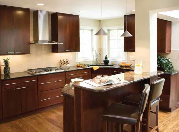 Inspiration for a transitional u-shaped eat-in kitchen remodel in Cincinnati with flat-panel cabinets, dark wood cabinets and beige backsplash