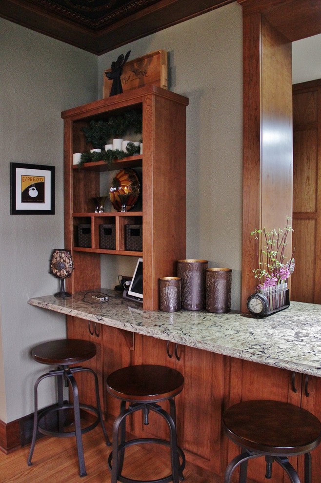 Mid-sized transitional galley ceramic tile enclosed kitchen photo with an undermount sink, shaker cabinets, medium tone wood cabinets, quartz countertops, beige backsplash, stone tile backsplash, stainless steel appliances and a peninsula