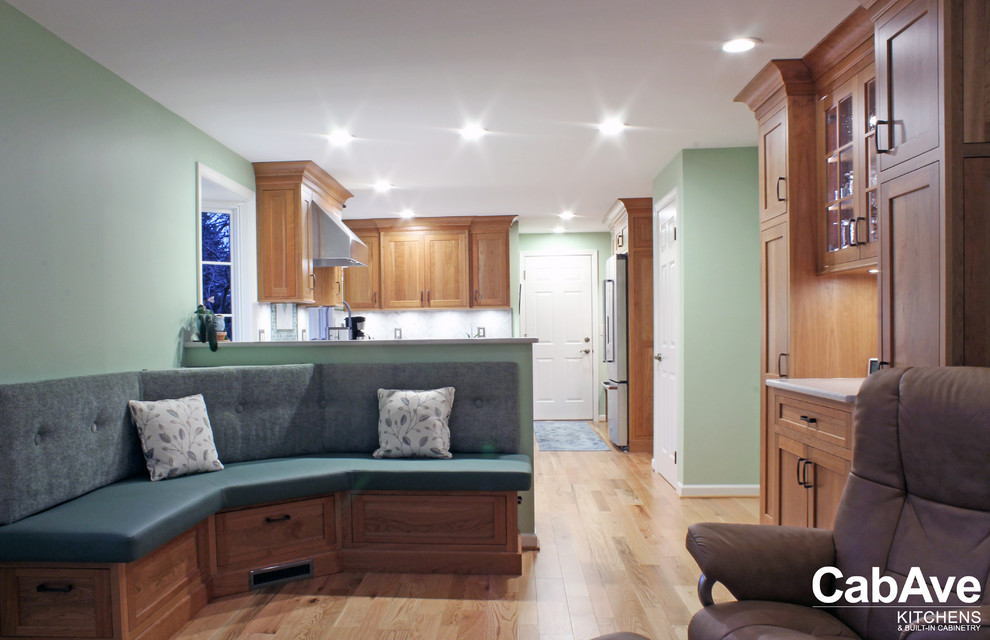 Example of a large transitional u-shaped light wood floor and beige floor open concept kitchen design with an undermount sink, recessed-panel cabinets, light wood cabinets, quartz countertops, green backsplash, mosaic tile backsplash, stainless steel appliances and a peninsula