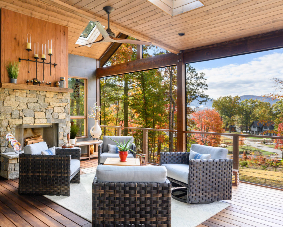 This is an example of a rustic back porch design with a roof extension.