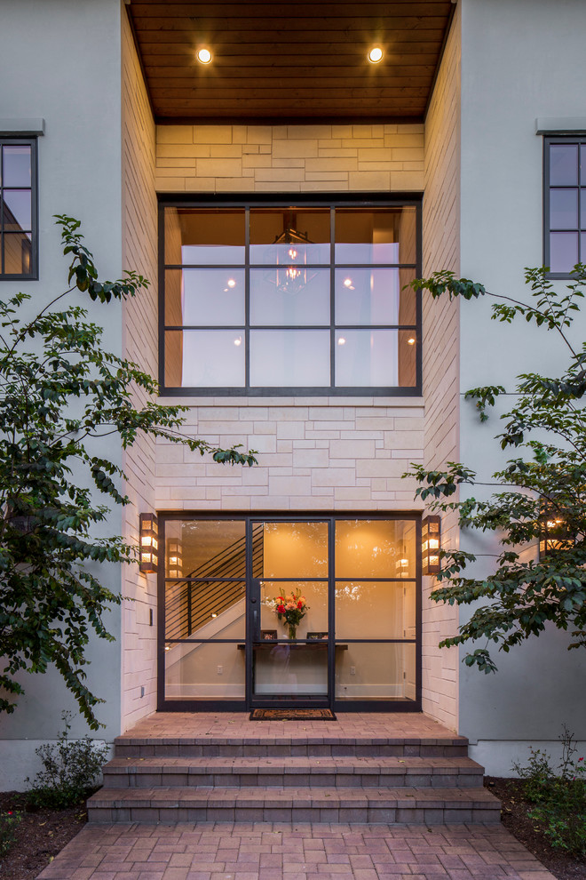 Design ideas for a mediterranean front door in Austin with beige walls, a single front door and a glass front door.