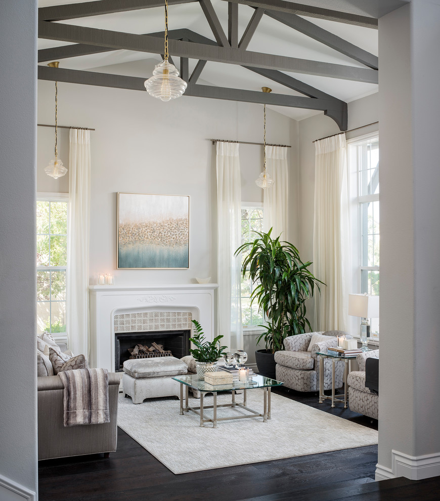 Inspiration for a large transitional formal open concept living room in Los Angeles with grey walls, dark hardwood floors, a standard fireplace, a tile fireplace surround and black floor.