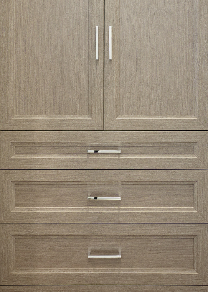 Inspiration for a mid-sized transitional women's walk-in wardrobe in New York with recessed-panel cabinets, grey cabinets and medium hardwood floors.